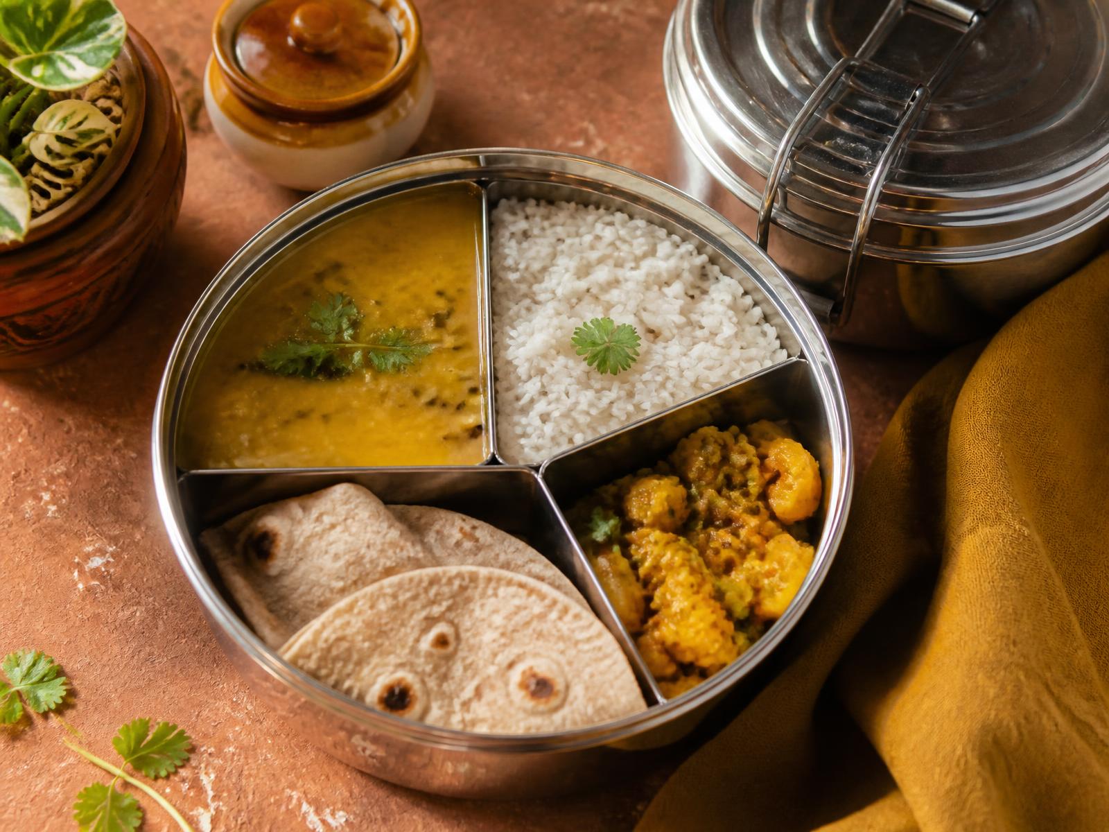 Freshly packed Indian tiffin with dal, rice, roti and sabzi